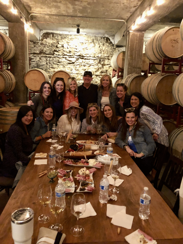 A Private Libation Tour Group Smiling Gathered At A Table